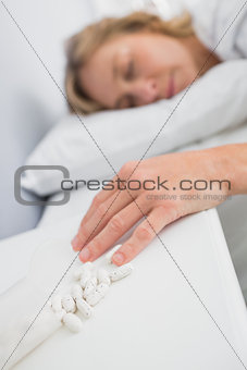 Blonde woman lying motionless after overdose of pills