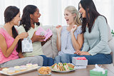 Friends offering gifts to woman during party