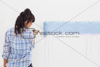 Woman painting wall blue