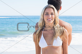 Beautiful blonde smiling and leaning against her boyfriend