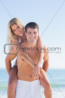 Man giving his pretty girlfriend a piggy back