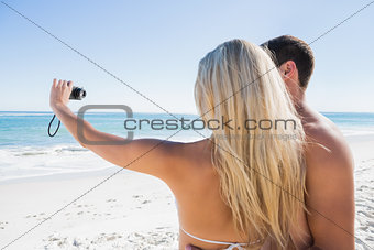 Blonde taking picture of herself with boyfriend