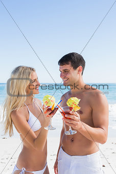 Attractive young couple holding cocktails