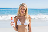 Beautiful blonde holding ice lolly