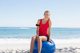 Fit young blonde sitting on exercise ball