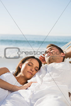 Peaceful couple sleeping in a hammock