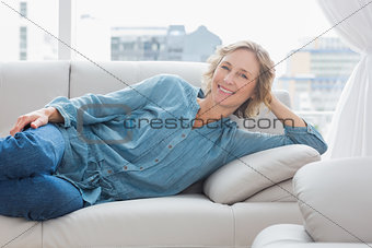 Smiling woman relaxing on her couch