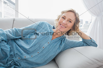 Cheerful woman relaxing on her couch