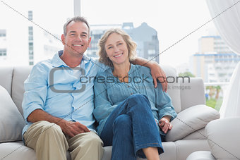 Happy couple relaxing on their couch