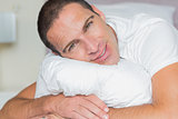 Attractive man hugging his pillow