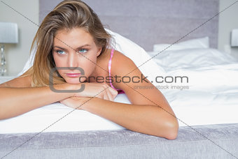 Thoughtful blonde lying on her bed