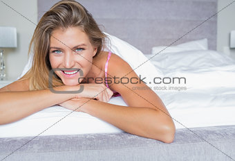 Happy blonde lying on her bed