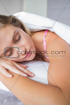Beautiful blonde lying on her bed asleep