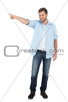 Confident model looking at camera while pointing