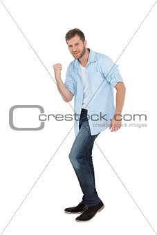 Handsome man posing with clenched fist