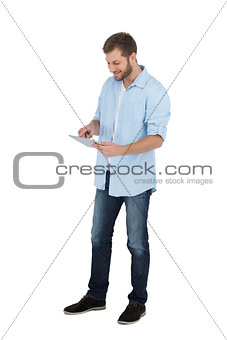 Relaxed male model using his tablet pc