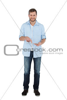Relaxed male model posing with tablet computer