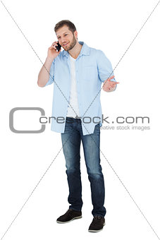 Relaxed male model posing while making a call