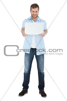 Relaxed model looking at his laptop