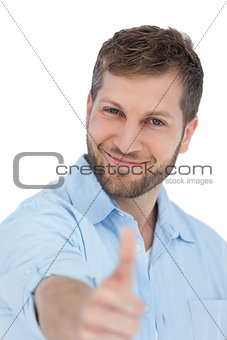Enthusiastic young model posing with thumbs up