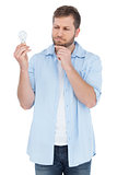 Sceptical model holding a bulb