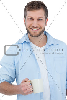 Smiling young model holding a mug