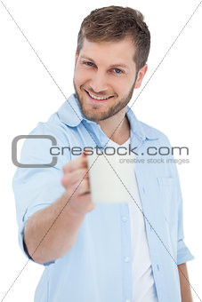 Smiling model offering a mug