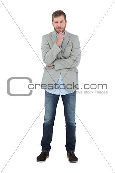 Thoughtful model posing in blazer looking at camera