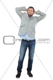 Suave man in a blazer with hands behind head