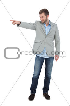 Smiling trendy model pointing to something