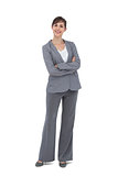 Cheerful businesswoman with arms crossed smiling at camera
