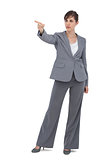 Young businesswoman pointing to something
