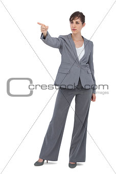 Young businesswoman pointing to something