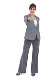 Businesswoman posing and pointing at camera