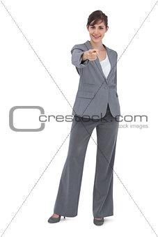Businesswoman posing and pointing at camera
