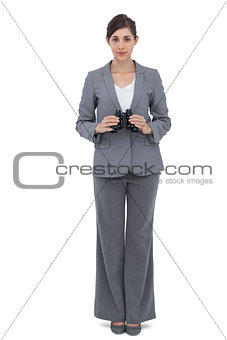 Young businesswoman with binoculars