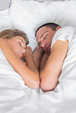 Cute couple asleep together in bed