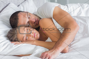 Cute couple sleeping and cuddling in bed