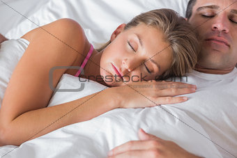 Peaceful couple sleeping and cuddling in bed