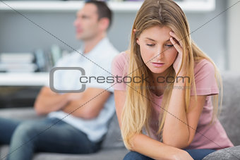 Couple not talking after a fight on the sofa
