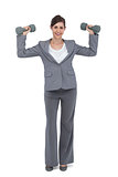 Businesswoman with dumbbells