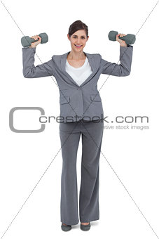 Businesswoman with dumbbells