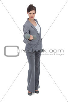 Businesswoman exercising with dumbbells