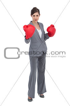 Competitive woman with red boxing gloves