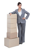 Smiling businesswoman with cardboard boxes