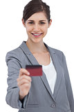Smiling businesswoman holding credit card