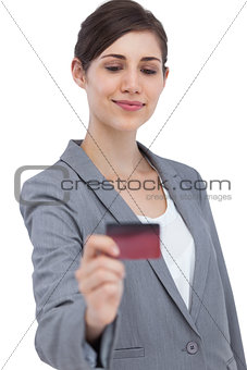 Confident businesswoman holding credit card