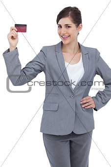 Smiling businesswoman with red credit card