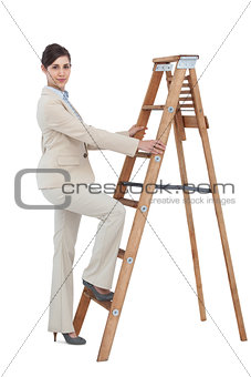 Businesswoman climbing career ladder