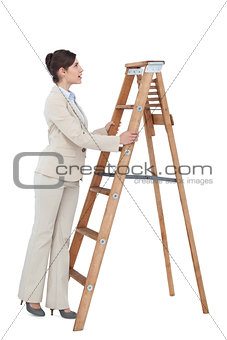 Cheerful businesswoman looking up the career ladder